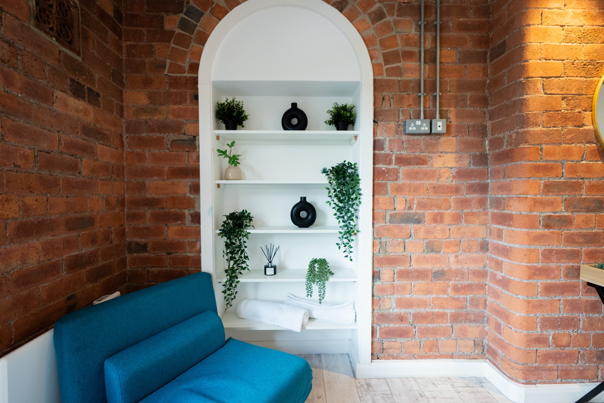 Blue chair and arched shelving